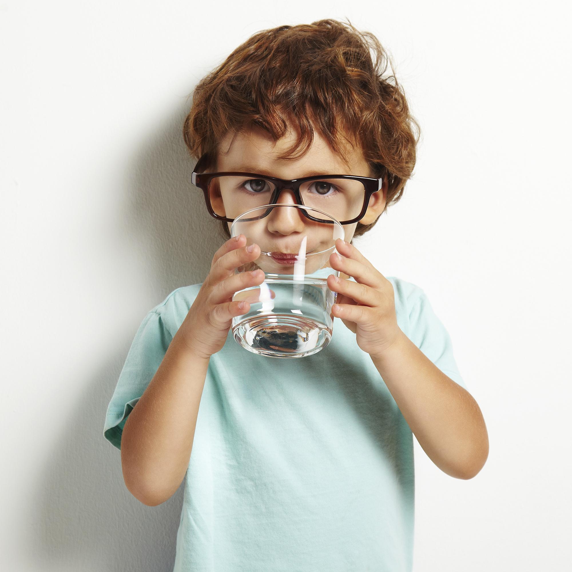 A child drinking water from a glass