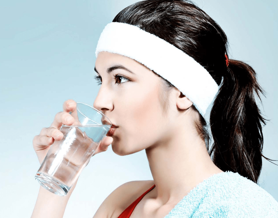 A Girl Drinking Water From A Clear Glass